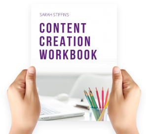Hands up holding copy of Content Creation Workbook